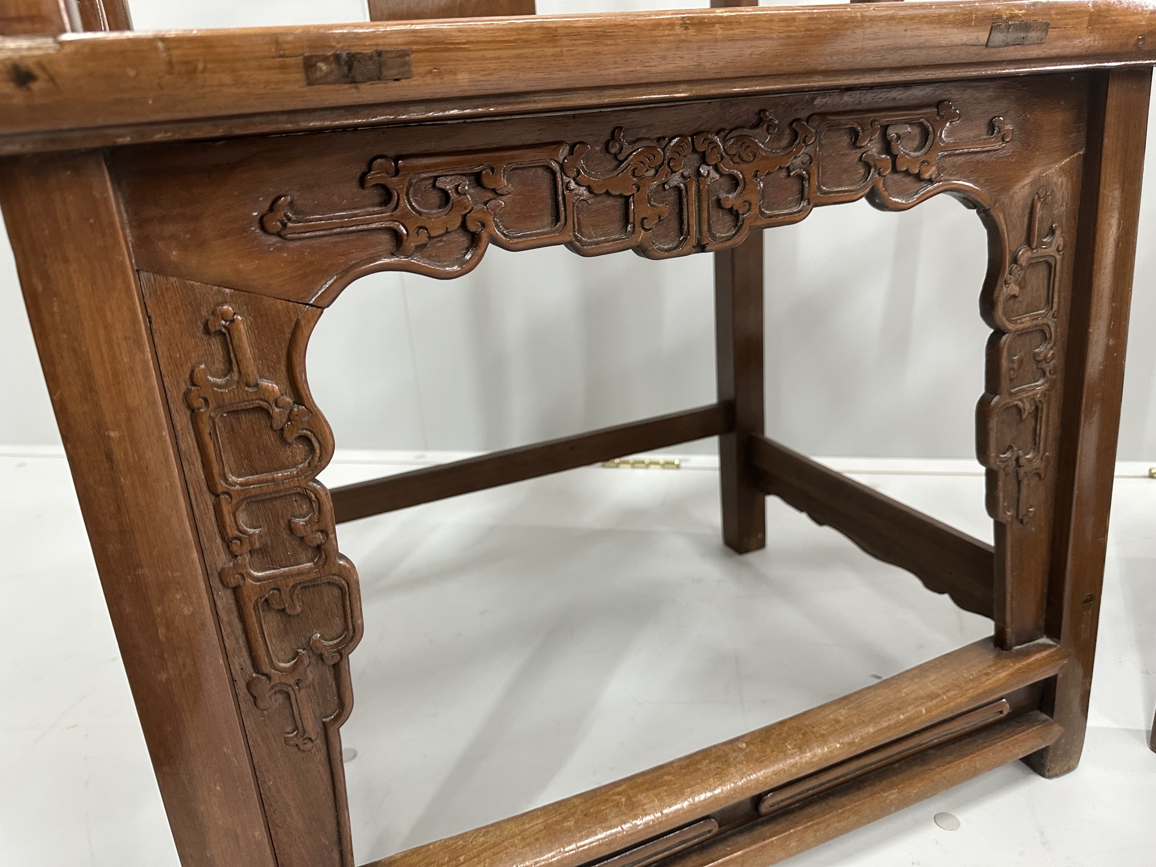 A pair of Chinese hardwood elbow chairs, width 56cm, depth 44cm, height 107cm